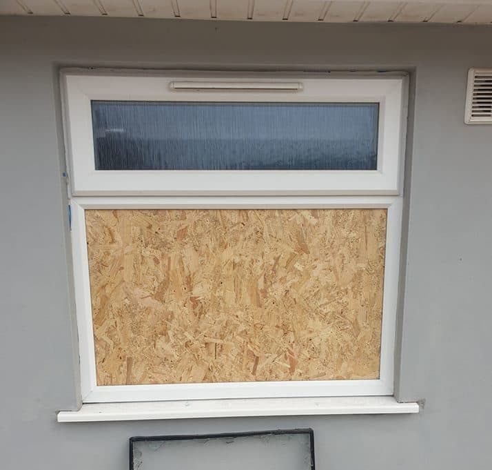 Boarded vacant property window used as temporary site protection